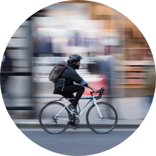 black man riding bike fast through city that may need ATLANTA BICYCLE ACCIDENT LAWYERS if he is in a bicycle accident