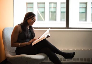 black woman doing research relaxed in library