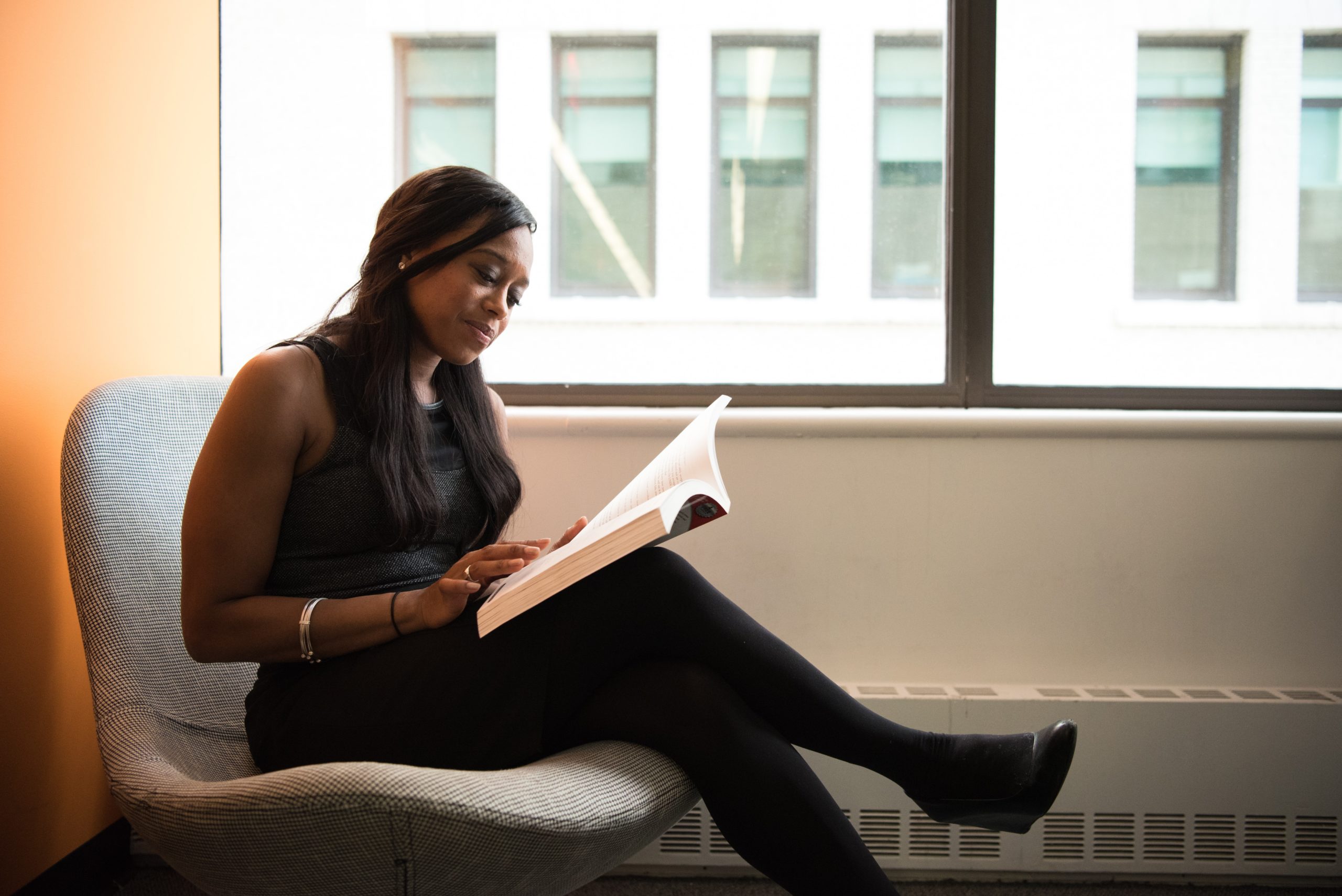 black woman doing research relaxed in library