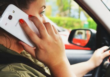 woman talking on phone while driving