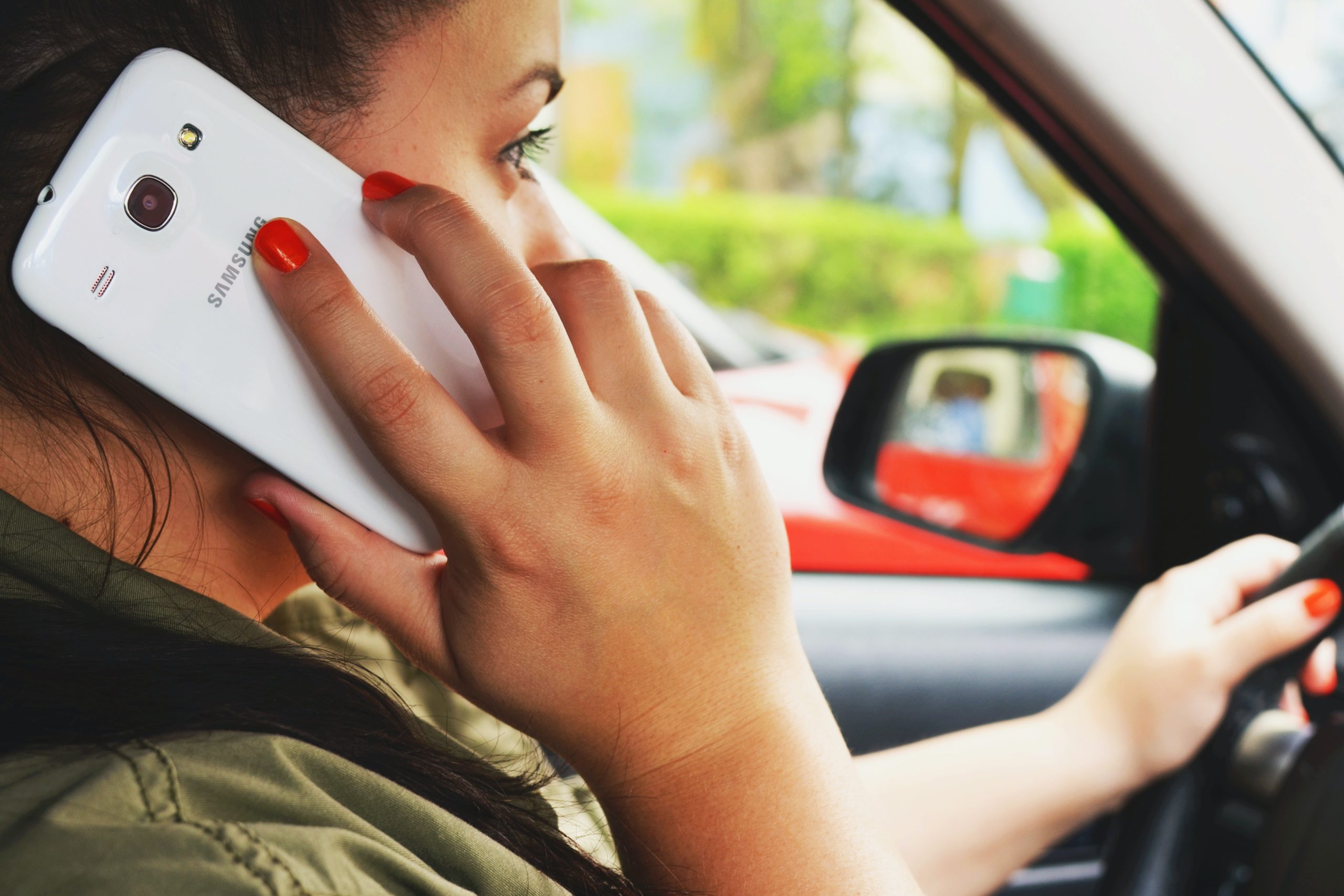 woman talking on phone while driving