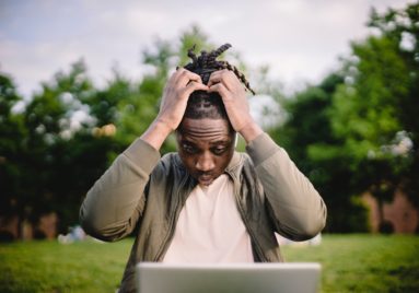 anxious man looking at computer