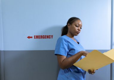 black nurse looking in file