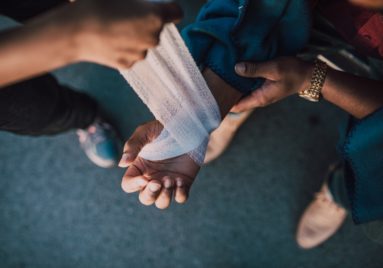 injured hand being wrapped in bandage