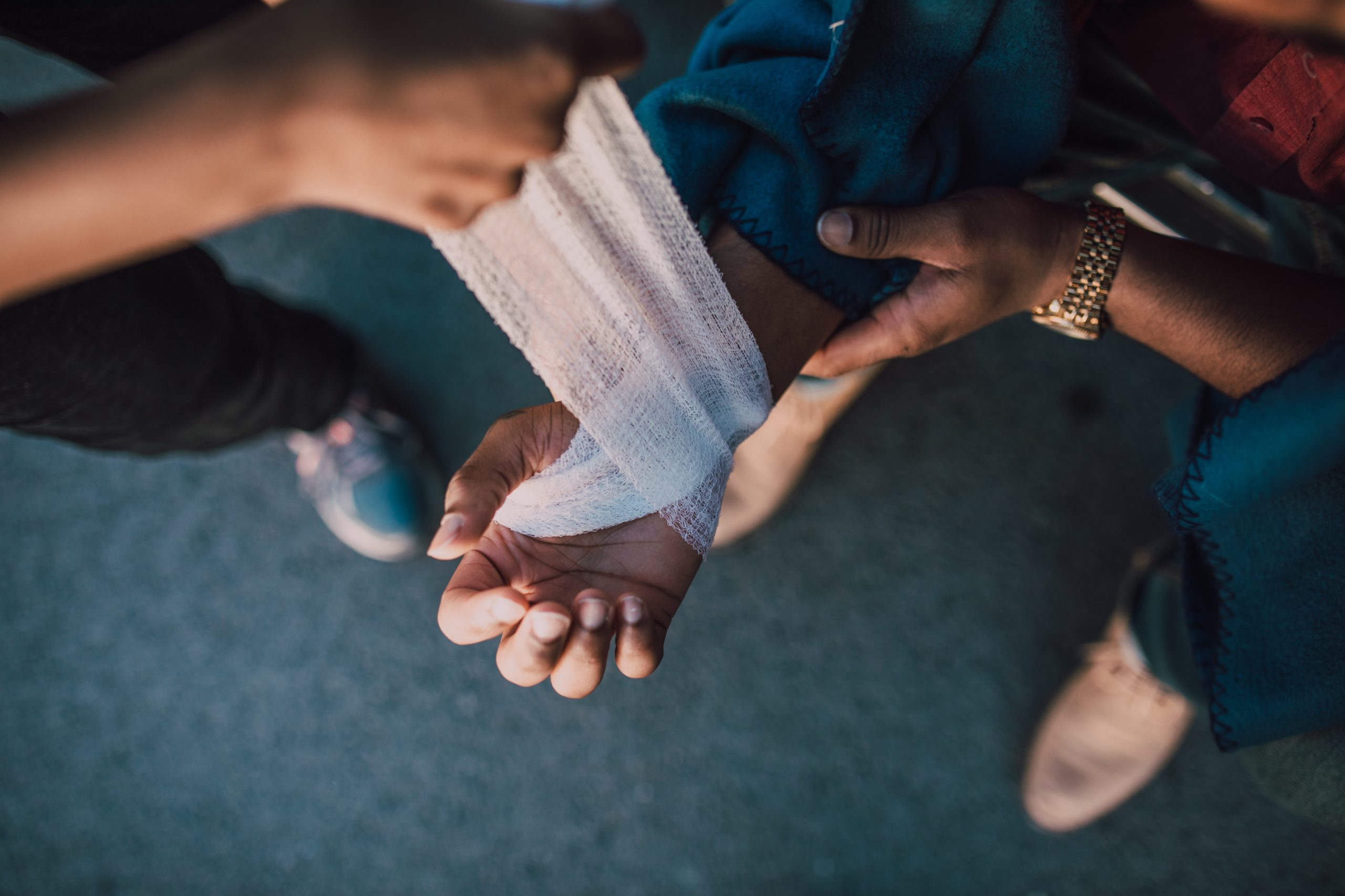 injured hand being wrapped in bandage