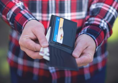 person pulling a few bills out of their wallet to show lost wages after a personal injury accident